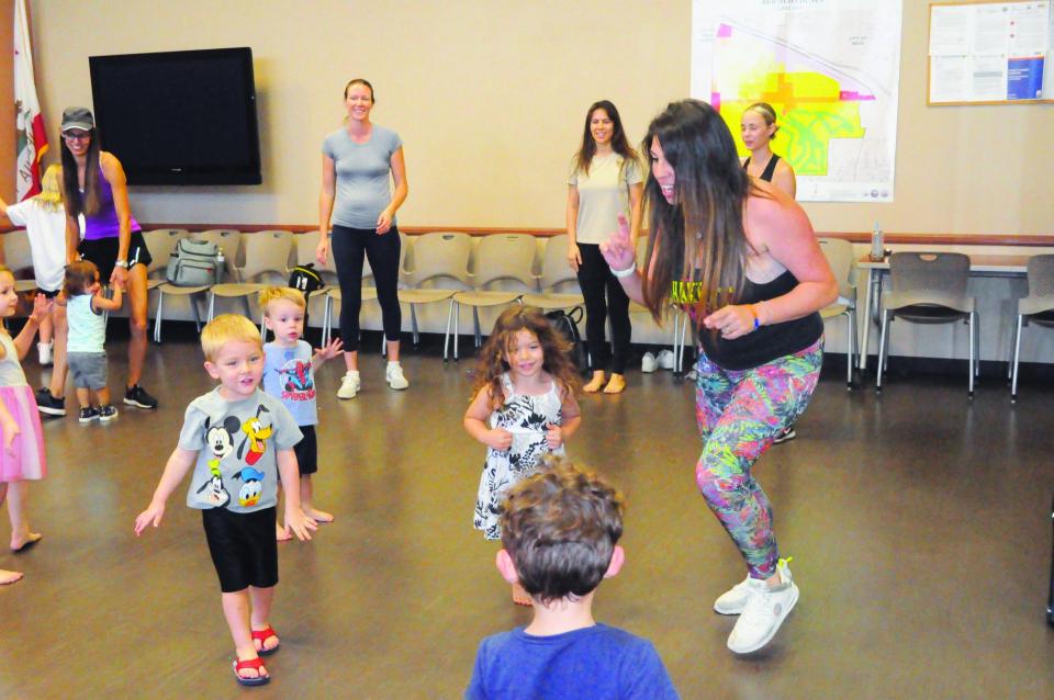 Adult female instructor with tots dancing